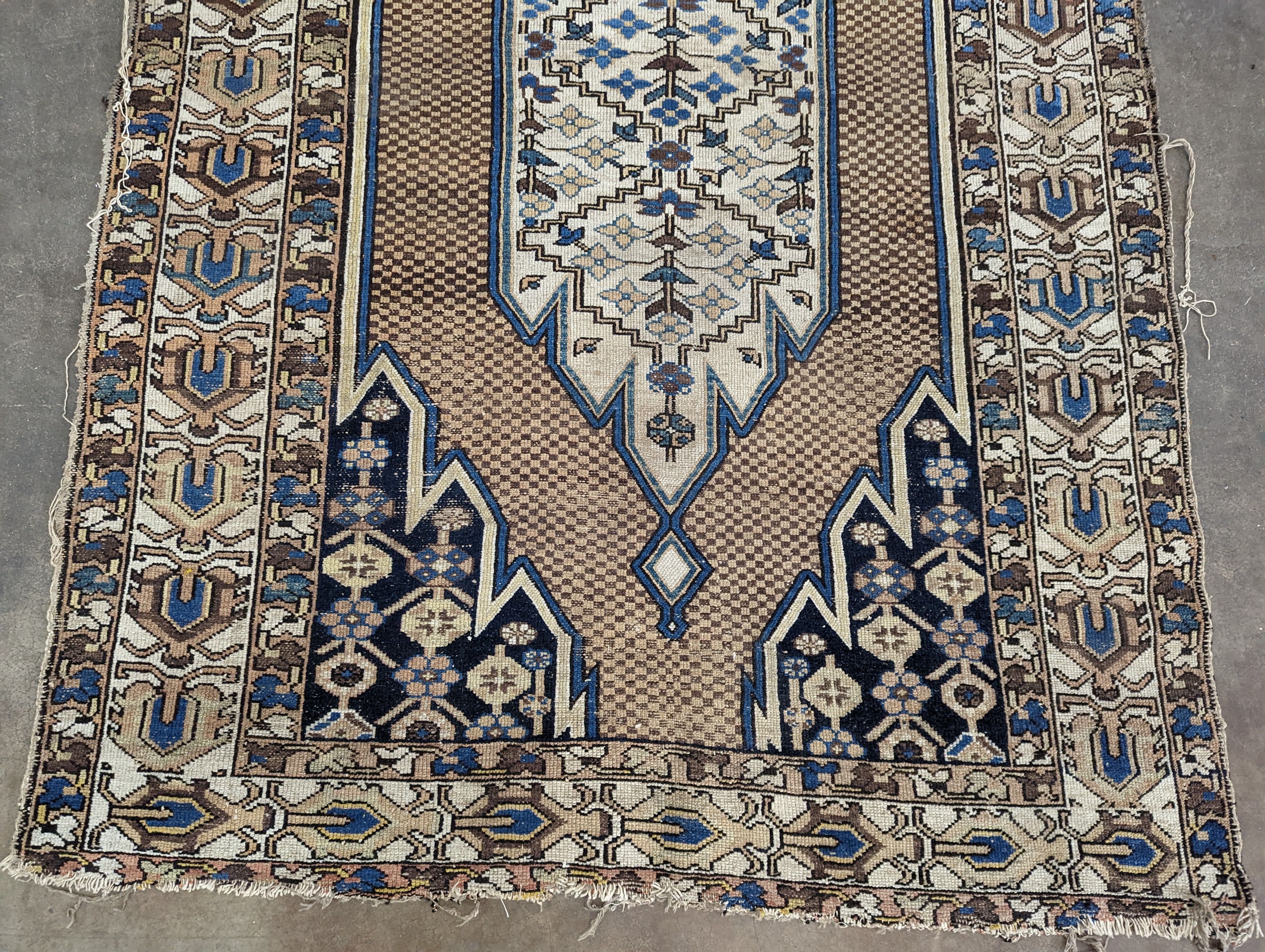 A Soumak rug, the fawn field with chevron borders, 196 x 126cm